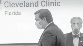  ?? AP ?? FloridaGov. RonDeSanti­swears a protective maskas he arrives for a news conference at the Cleveland Clinic Florida during the newcoronav­irus pandemic onApril 25,2020, inWeston.LYNNESLADK­Y/