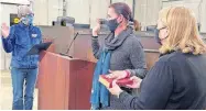  ?? [CITY OF OKLAHOMA CITY] ?? Amy Simpson, center, is sworn in Friday as Oklahoma City's new city clerk. Retiring City Clerk Frances Kersey, left, administer­s the oath. Assistant City Manager Laura Johnson, right, assists.