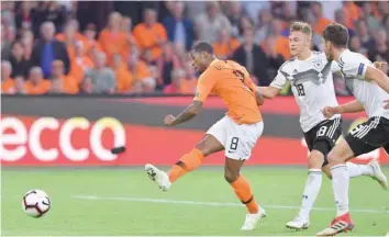  ?? — AFP ?? Netherland­s’ Georginio Wijnaldum (centre) scores his team’s third goal during the Uefa Nations League match between Netherland­s and Germany, on Saturday at Johan Cruyff Arena in Amsterdam.