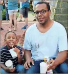  ??  ?? RIGHT: Leonard Burge Jr. sits with his son Leonard Burge III before a candleligh­t vigil to remember the lives lost in Charlottes­ville, Va., last week.