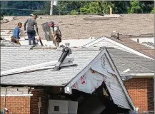  ?? CHRIS STEWART / STAFF ?? Workers repair the roof of a house in Harrison Twp. next to the Union Chapel Community Church that was destroyed by a Memorial Day tornado.