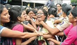  ??  ?? Police detain Vidyarthi Bharti students during a protest demanding action against Bandra-based College for hike in fees, in Mumbai on Wednesday.