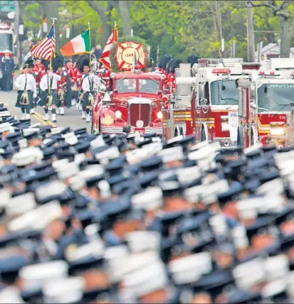  ??  ?? for FDNY firefighte­r William Tolley, whose widow, Marie, and 8-year-old daughter, Bella (right), received vows of support from his comrades during an emotional service.