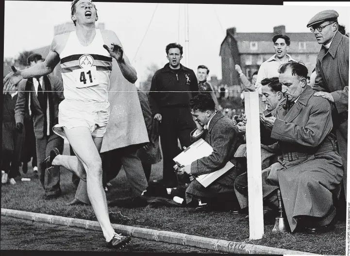  ??  ?? Breathtaki­ng moment: Roger Bannister hits the tape at three minutes 59.4 seconds