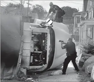  ?? DAY FILE PHOTO ?? New London police Officer Thomas Northup, right, fires his gun into the cab of an overturned ice truck at Curtis Cunningham, 27, of New Haven after he allegedly stole the truck and rolled it over at the intersecti­on of Bank Street and Jefferson Avenue on Aug. 24, 2011.