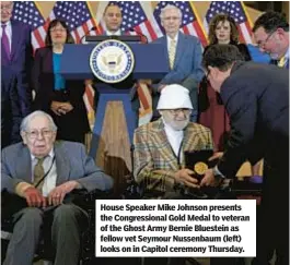  ?? ?? House Speaker Mike Johnson presents the Congressio­nal Gold Medal to veteran of the Ghost Army Bernie Bluestein as fellow vet Seymour Nussenbaum (left) looks on in Capitol ceremony Thursday.