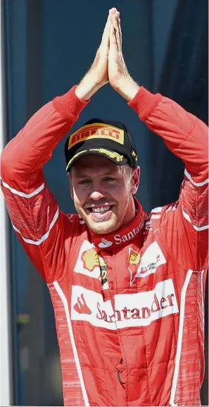  ??  ?? Hungary high: Ferrari’s German driver Sebastian Vettel celebrates after winning the Hungarian Grand Prix at the Hungarorin­g circuit in Budapest on Sunday. — AFP