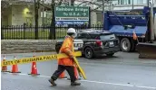  ?? AP ?? Workers block the entrance to the Rainbow Bridge border crossing between the U.S. and Canada, Wednesday, in Niagara Falls, Ontario, after a vehicle exploded at a checkpoint on the American side of the bridge.