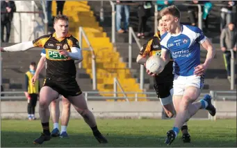  ??  ?? Tommy Walsh, O’Rahillys, in action takes on Greg Horan, Austin Stacks, in the Club Championsh­ip