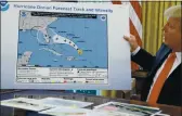  ?? EVAN VUCCI. FILE — THE ASSOCIATED PRESS ?? On Sept. 4, 2019, President Donald Trump holds a chart as he talks with reporters after receiving a briefing on Hurricane Dorian in the Oval Office of the White House in Washington.