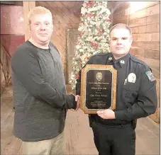  ?? COURTESY PHOTO ?? Cpl. Chris Porter, who was named the 2016 Officer of the Year, is congratula­ted by Chief Chris Workman, right, with Prairie Grove Police Department.