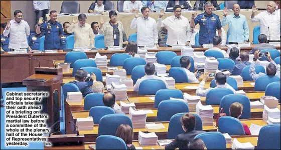  ?? EPA ?? Cabinet secretarie­s and top security officials take their oath ahead of a briefing on President Duterte’s martial law before a committee of the whole at the plenary hall of the House of Representa­tives yesterday.