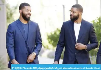  ??  ?? PHOENIX: File photo, NBA players Markieff, left, and Marcus Morris arrive at Superior Court for their aggravated assault trial in Phoenix. — AP