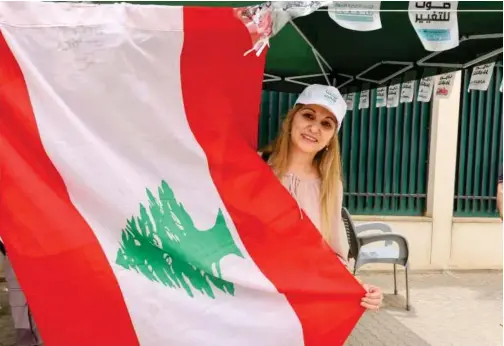 ?? Reuters ?? A Lebanese expat poses with a flag after casting a vote in Lebanon’s parliament­ary election at the Lebanese embassy in Riyadh, Saudi Arabia, on May 6.