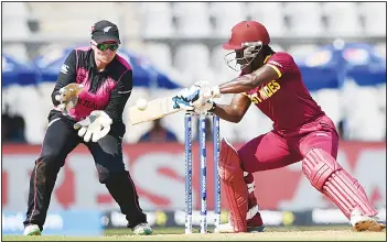  ??  ?? New Zealand wicketkeep­er Rachel Priest (left), looks on as West Indies cricketer Britney Cooper plays a shot during theWorld T20 women’s semifinal match between New Zealand and West Indies in Mumbai on March 31.