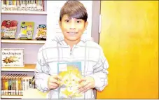  ?? RACHEL DICKERSON/MCDONALD COUNTY PRESS ?? Christian Rubio, fifth-grader at Noel Elementary, is pictured with The
Lion, the Witch and the Wardrobe, the book for this year’s One Book, One
County countywide read-along.