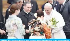  ?? — AFP ?? TOKYO: Pope receives flowers from women dressed in kimonos as he leaves Tokyo’s Haneda airport yesterday.