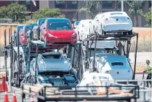  ?? DAVID PAUL MORRIS/BLOOMBERG NEWS ?? Tesla vehicles are loaded for transport at the company’s manufactur­ing facility in Fremont, Calif., on June 20.