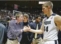  ??  ?? Purdue center Isaac Haas, right, shakes hands with Speidel after he was introduced with the Vermont players before a November 2015 game.