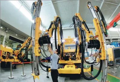  ?? CHEN XIAODONG / FOR CHINA DAILY ?? A technician checks drilling equipment at a private company in Xuanhua, Hebei province.