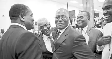  ??  ?? Provisiona­l president candidates Edgar Leblanc Fils (second left) and Jocelerme Privert (centre) greet each other during the Special Bicameral Commission for the election of the provisiona­l President of the Republic in the Haitian Parliament in Port-au-Prince, Haiti. — Reuters photo