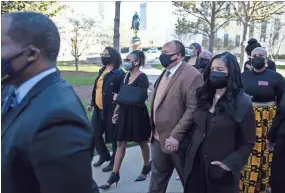  ?? AP-Ben Gray ?? Georgia State Rep. Park Cannon, D-Atlanta,, center with arm in sling, walks beside Martin Luther King, III, as she returns to the State Capitol in Atlanta on Monday morning, March 29, 2021 after being arrested last week for knocking on the governor’s office door as he signed voting legislatio­n.