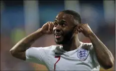  ?? AP PHOTO/DARKO VOJINOVIC ?? In this March 25 file photo, England’s Raheem Sterling celebrates scoring his side’s fifth goal after hearing racist chants, during their Euro 2020 group A qualifying soccer match against Montenegro at the City Stadium in Podgorica, Montenegro.