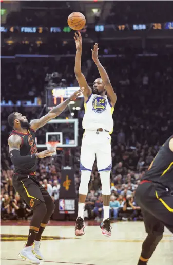  ?? Scott Strazzante / The Chronicle ?? Kevin Durant pulls up for a shot over LeBron James in the third quarter. Durant had 43 points, 13 rebounds and seven assists to lead the Warriors to one win from the NBA championsh­ip.