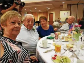  ?? DAN SOKIL — DIGITAL FIRST MEDIA ?? Bill Herger of Sanatoga, who is 100 years old, poses with his daughters Gail and Mary and fellow centenaria­n Harry Newman, at right, durig a luncheon for centenaria­ns hosted by the Montgomery County Office of Aging and Adult Services on Thursday.