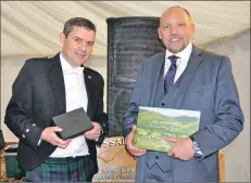  ??  ?? Robin Russell, right, is made an Arran Ambassador by managing director Euan Mitchell.