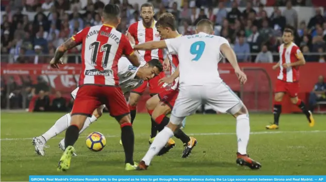  ?? — AP ?? GIRONA: Real Madrid’s Cristiano Ronaldo falls to the ground as he tries to get through the Girona defence during the La Liga soccer match between Girona and Real Madrid.