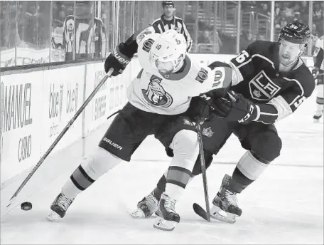  ?? Photograph­s by Chris Carlson Associated Press ?? OTTAWA SENATORS winger Tom Pyatt, left, battles for the puck with Kings defenseman Kurtis MacDermid during the first period.