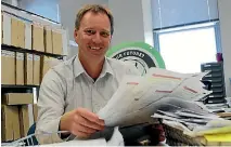  ?? PHOTO: STEPHEN DORAN/SUPPLIED ?? TDC Corporate Planning Manager Mark Low rifles through some of the submission­s.