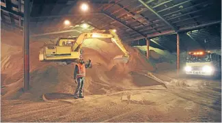  ??  ?? Palm kernel extract being unloaded in a Timaru warehouse.