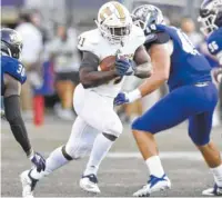  ?? STAFF FILE PHOTO BY ROBIN RUDD ?? UTC running back Tyrell Price runs the ball against Western Carolina during a game on Oct. 13.