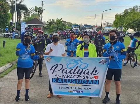  ?? (City of San Fernando Informatio­n Office) ?? BIKING TOWARDS HEALTH AND FITNESS. City of San Fernando Acting Mayor Jimmy Lazatin, Acting ViceMayor BJ Lagman and personnel of the City Human Resource Management Office lead the first-ever cycling caravan for the City Government employees on September 17, 2021.