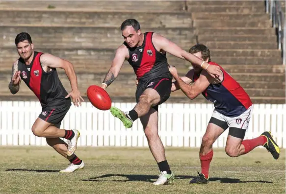  ?? Photo: Nev Madsen ?? UNDER PRESSURE: Justin Baker kicking forward for South Toowoomba against Warwick last weekend. The Bombers need another positive result against Goondiwind­i today.