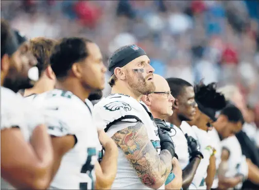  ??  ?? MARY SCHWALM | APMEMBERS OF THE Philadelph­ia Eagles stand during the playing of the national anthem before a preseason game. Several Eagles players, however, have protested this preseason and coach Doug Pederson says they have a right to do so if they choose.
