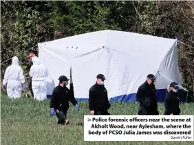  ?? Gareth Fuller ?? > Police forensic officers near the scene at Akholt Wood, near Aylesham, where the body of PCSO Julia James was discovered