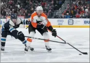  ?? JAY LAPRETE — THE ASSOCIATED PRESS ?? Philadelph­ia Flyers’ Kevin Hayes, right, carries the puck across the blue line as Columbus Blue Jackets’ Eric Robinson defends during the third period of an NHL hockey game Thursday in Columbus, Ohio.