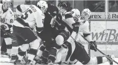  ?? MICHAEL BELL ?? Pats centre Jake Leschyshyn is bowled over during a scrum in the crease during Wednesday night’s loss to visiting Moose Jaw. The Warriors have won all five games between the two teams this season.