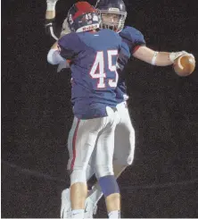  ?? HERALD PHOTO BY JIM MICHAUD ?? GET UP! Lincoln-Sudbury’s Kyle Smith (45) celebrates a touchdown run by teammate James Dillion (3) in last night’s game against Wayland.