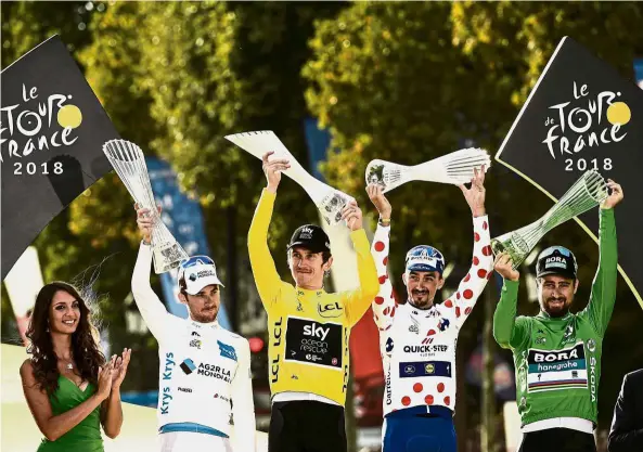  ?? — AFP ?? All the winners: (From second left) France’s Pierre-Roger Latour wearing the best young’s white jersey, Tour de France winner Britain’s Geraint Thomas wearing the overall leader’s yellow jersey, France’s Julian Alaphilipp­e wearing the best climber’s...