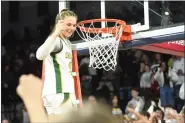  ?? MIKE CABREY/MEDIANEWS GROUP ?? Lansdale Catholic’s Gabby Casey celebrates after cutting a piece of the net to celebrate the Crusaders’ Philadelph­ia Catholic League championsh­ip on Monday, Feb. 27, 2023 at the Palestra in Philadelph­ia.