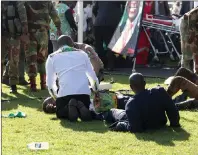  ?? AP PHOTO ?? Injured people are attended to as they lay on the ground following an explosion at a Zanu pf rally in Bulawayo on Saturday.