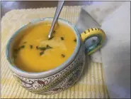  ?? JANET PODOLAK — FOR THE NEWS-HERALD ?? The soup, emulsified after cream, ginger and chicken broth are added, is served with a little shredded Swiss cheese and topped with chopped chives.