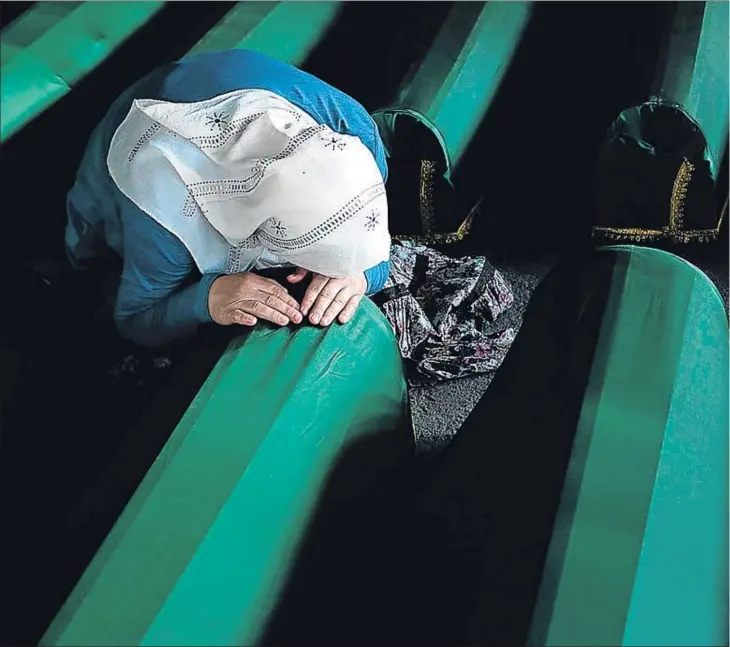  ??  ?? Una mujer llora sobre el féretro de un allegado durante la ceremonia de entierro de centenares de personas encontrada­s en fosas en Srebrenica, en julio del 2014