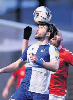  ??  ?? Bristol Rovers’ Luke Leahy heads the ball against Charlton