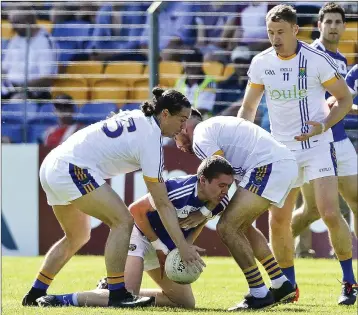  ??  ?? Wicklow’s Paul Cunningham and Darren Hayden combine to stop Laois’s Eoin Buggie.