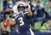  ?? JOHN FROSCHAUER — THE ASSOCIATED PRESS ?? Seattle Seahawks quarterbac­k Russell Wilson warms up for the team’s NFL football preseason game against the Los Angeles Chargers, Saturday in Seattle.